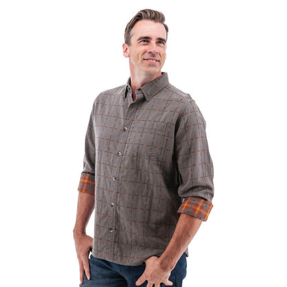 A man wearing the Old Ranch Men's Chase Shirt 25 in Blue Skies stands against a white background with rolled-up sleeves.