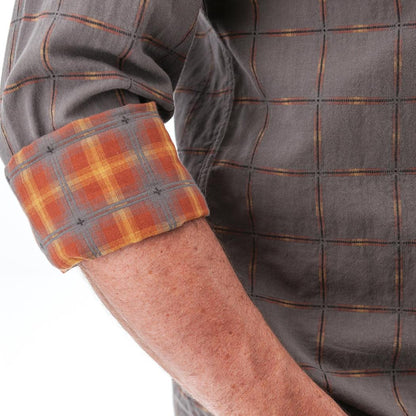 A close-up of the Old Ranch Men's Chase Shirt 25 in Blue Skies showing the rolled-up plaid cuff on a man's arm against a white background.