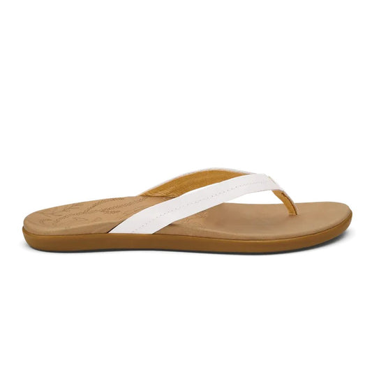 Side view of the Olukai Women's Honu sandals in Bright White / Golden Sand with a tan sole and white strap against a white background.