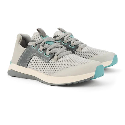 Side view of the Olukai Women's Wailuku in Mist Grey showing the mesh upper and light blue accents against a white background.