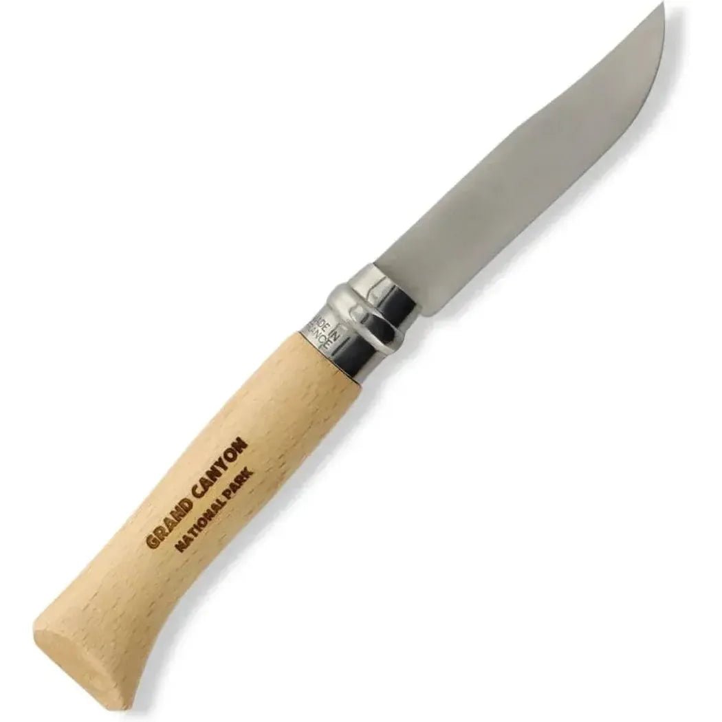 A side view of the Grand Canyon Opinel National Parks Collection knife with a light wood handle and stainless steel accents against a white background.