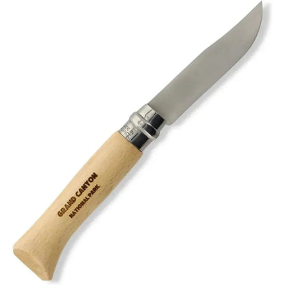 A side view of the Grand Canyon Opinel National Parks Collection knife with a light wood handle and stainless steel accents against a white background.