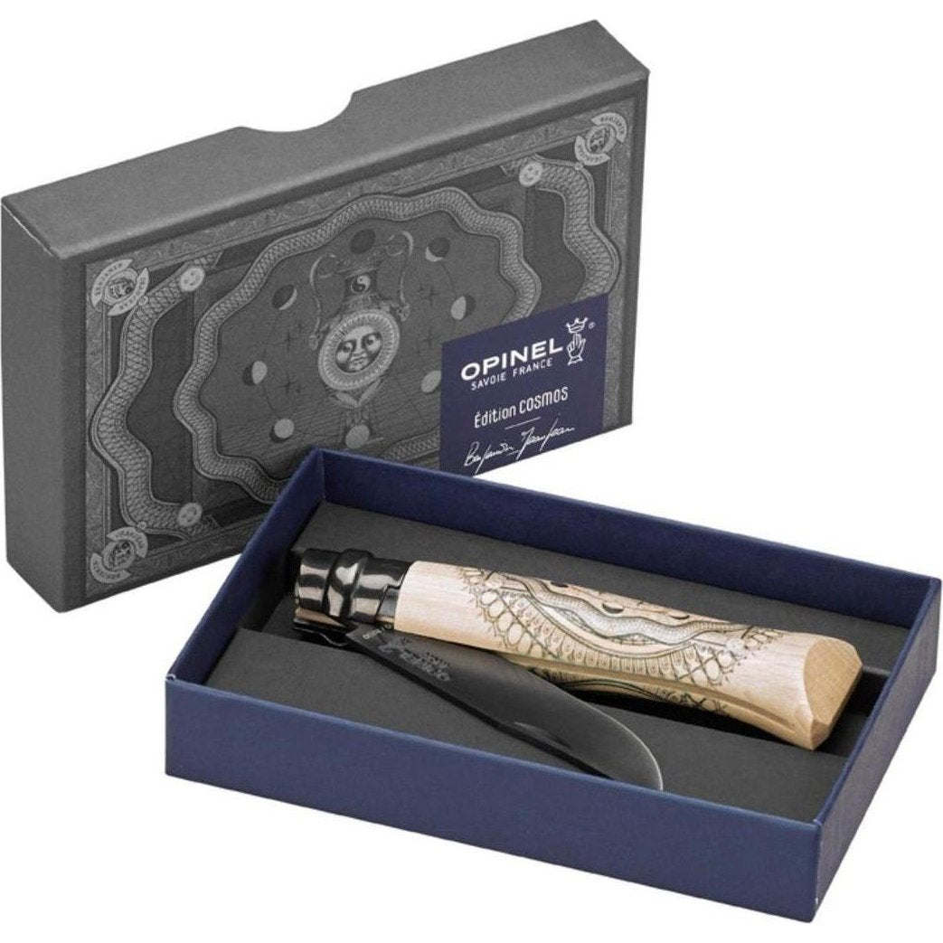 A top-down view of the Opinel No.08 Artist Limited V Cosmos Edition - Benjamin Jeanjean knife in its charcoal/gray box with a blue interior.