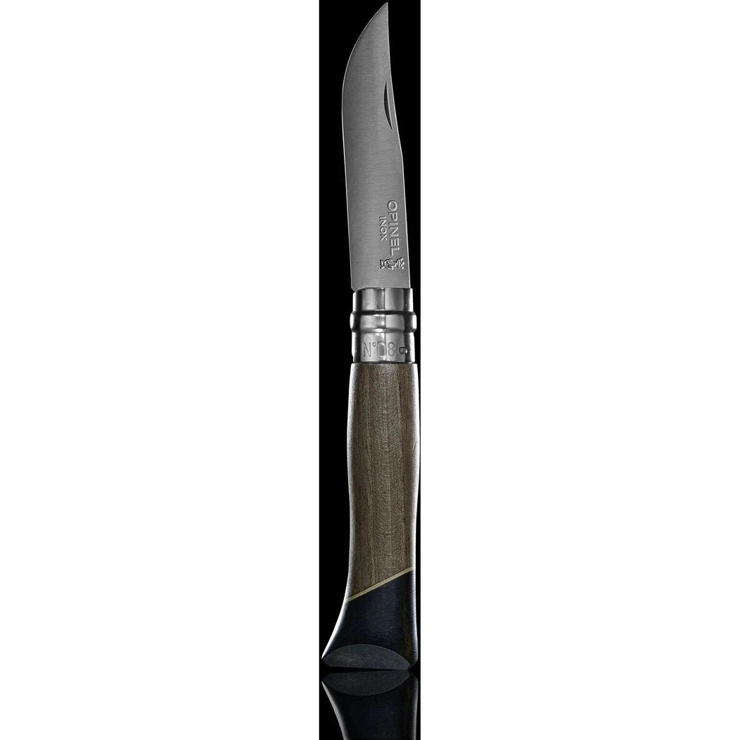 A side view of the Opinel No.08 Workshop knife with a charcoal/graphite handle and silver accents against a black background.
