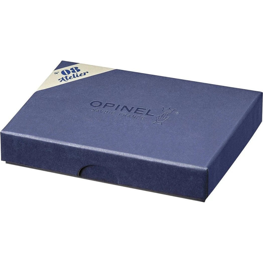 A top-down view of the Opinel No.08 Workshop gift box in a dark blue color with a white and blue label in the corner.