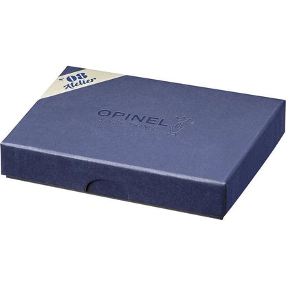 A top-down view of the Opinel No.08 Workshop gift box in a dark blue color with a white and blue label in the corner.