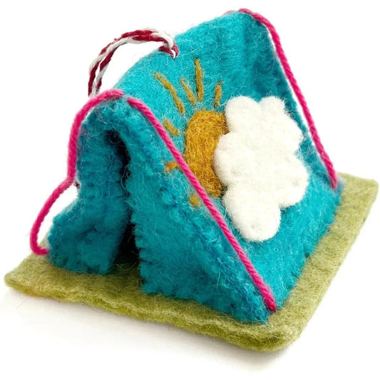 A turquoise felt Christmas ornament shaped like a tent with a sun and cloud design sits on a green base.