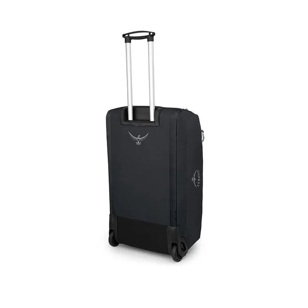 Back view of the Osprey Daylite Wheeled Duffel 85 in Black with telescoping handle and wheels against a white background.
