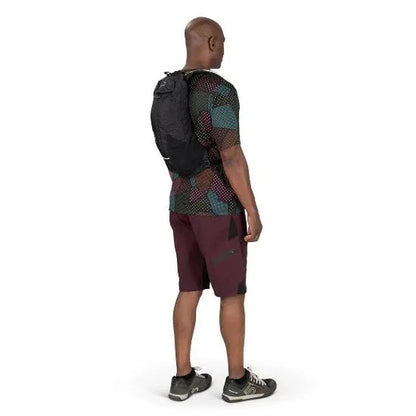 Back view of the Osprey Katari 7 Black hydration pack on a model against a white background.