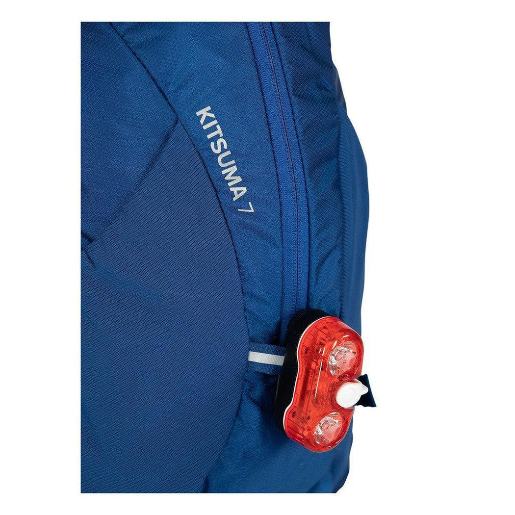 Side view of the Osprey Kitsuma 7 in SpaceTravelGrey showing the red rear light against a white background.