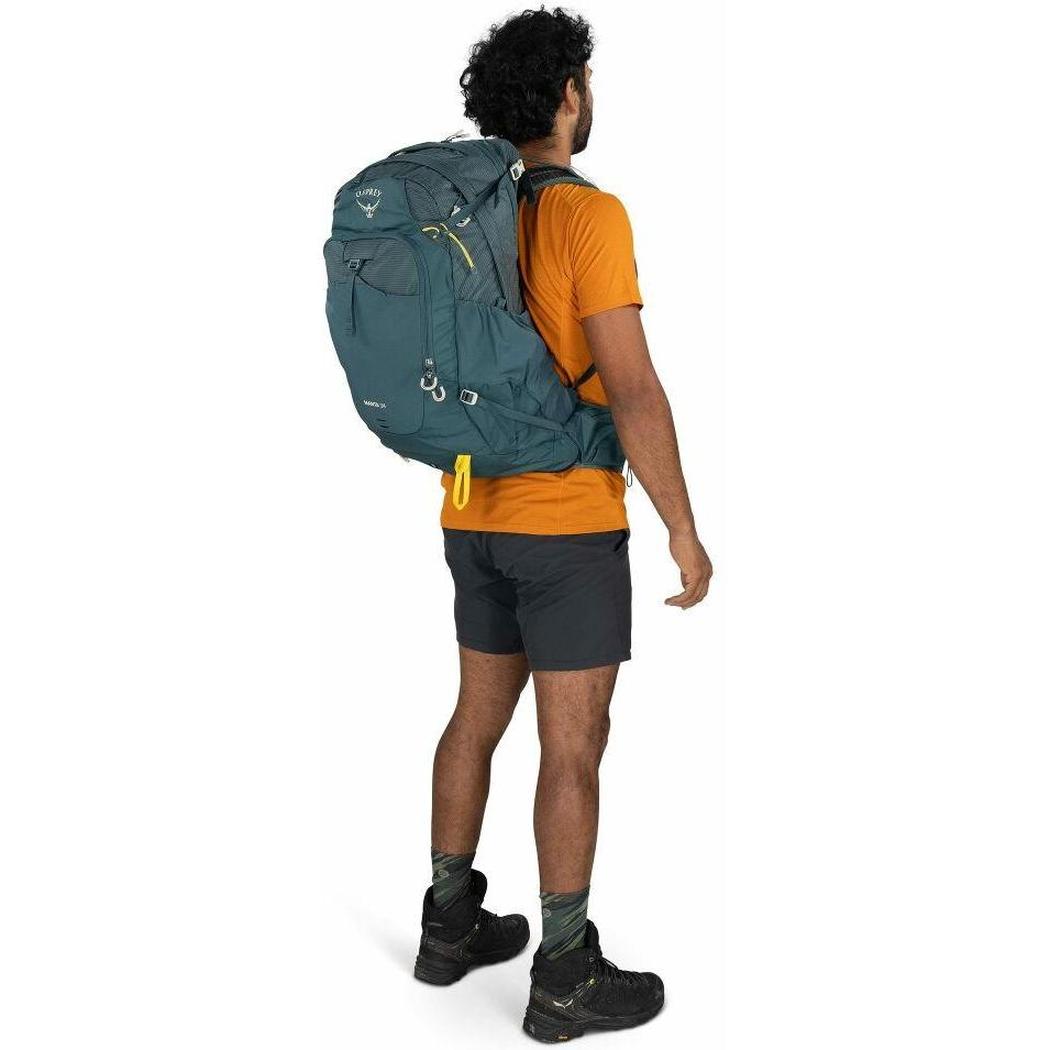 Back view of the Osprey Manta 34 Hiking Hydration Backpack in Dark Charcoal on a model against a white background.
