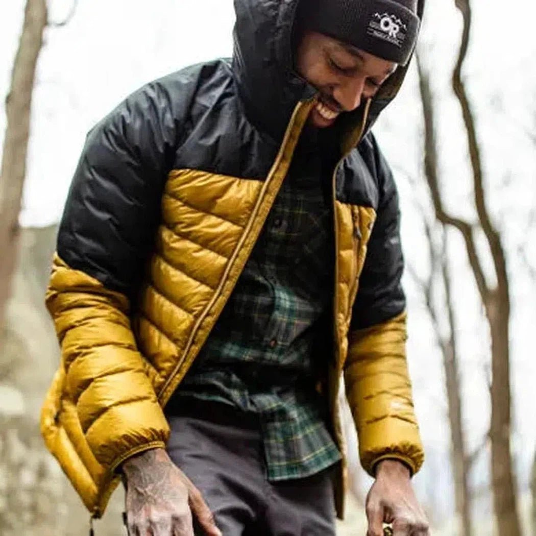 A model wears the Outdoor Research Juneau Beanie with a Charcoal/Graphite jacket in a wooded outdoor setting.