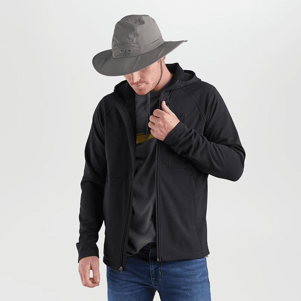 A model wears the Outdoor Research Sombriolet Sun Hat in Pewter, showing the wide brim and adjustable chin strap against a plain white background.