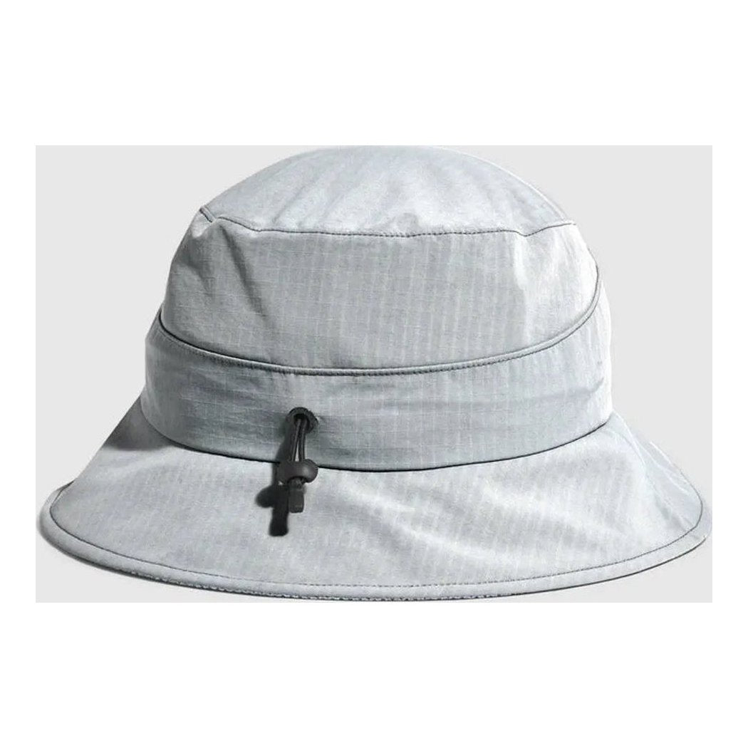 A front view of the Outdoor Research Sun Bucket Hat in Gravel with a black drawstring and a light gray background.