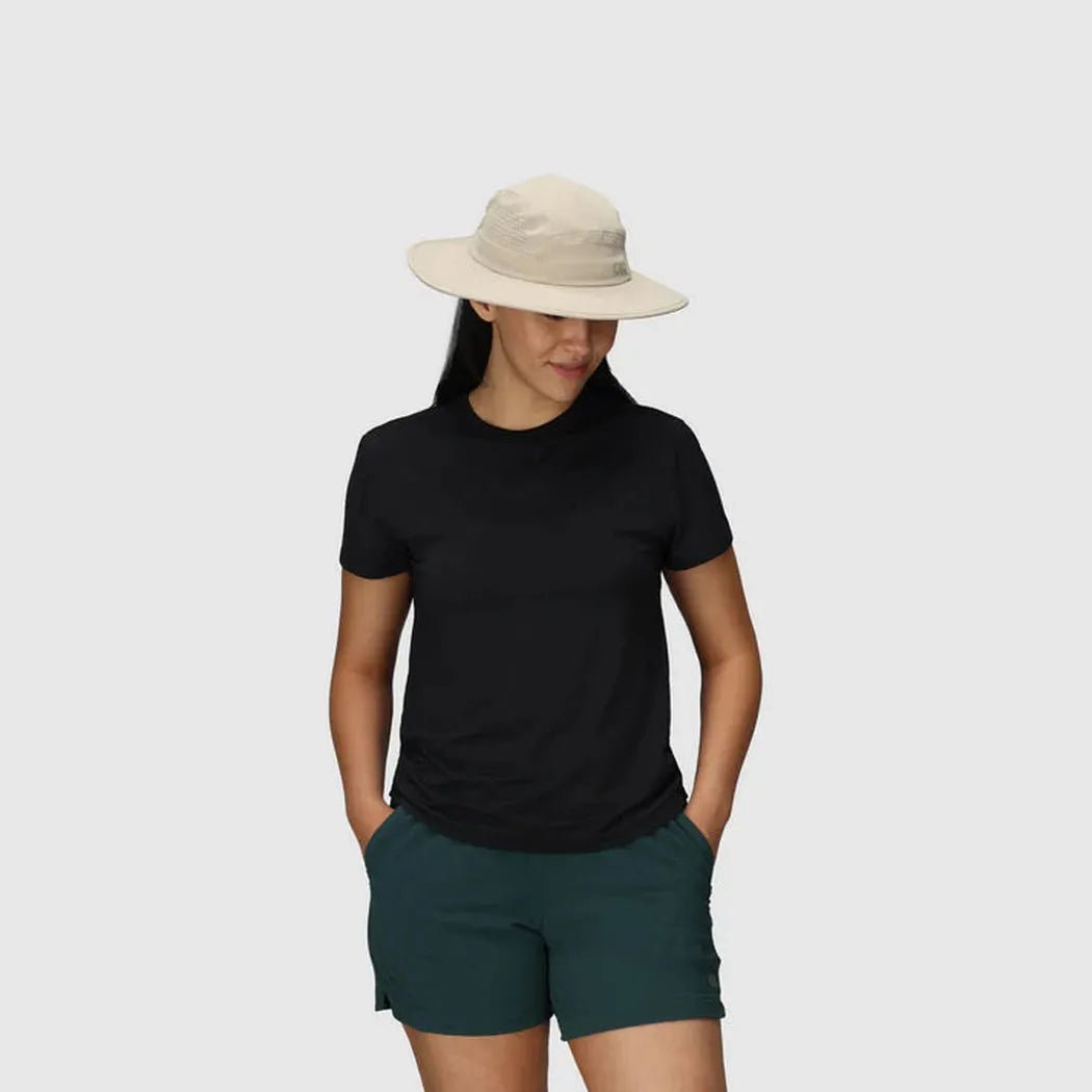 A model wears the Outdoor Research Swift Lite Brimmer hat in Atlantic color, standing against a plain white background.