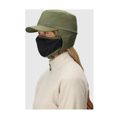Side view of the Outdoor Research Whitefish Hat in Atlantic showing the face covering feature on a model against a light background.
