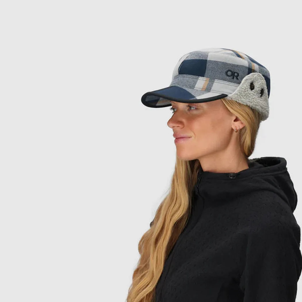 Side view of the Outdoor Research Yukon Cap in Black/Pewter Plaid on a model against a white background.