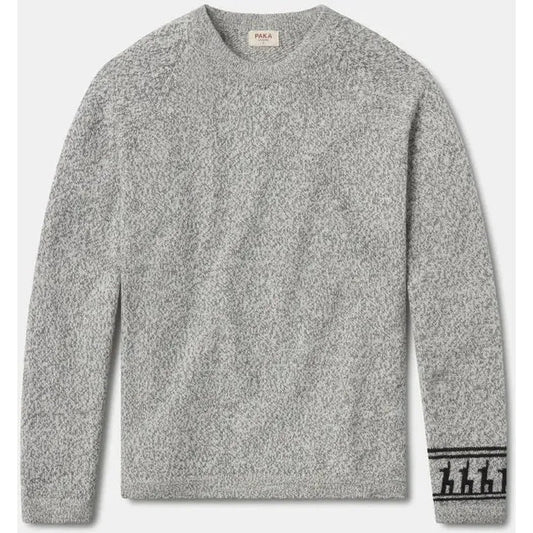 A front view of the Paka Apparel The Costa light grey sweater with a graphic on the cuff against a white background.