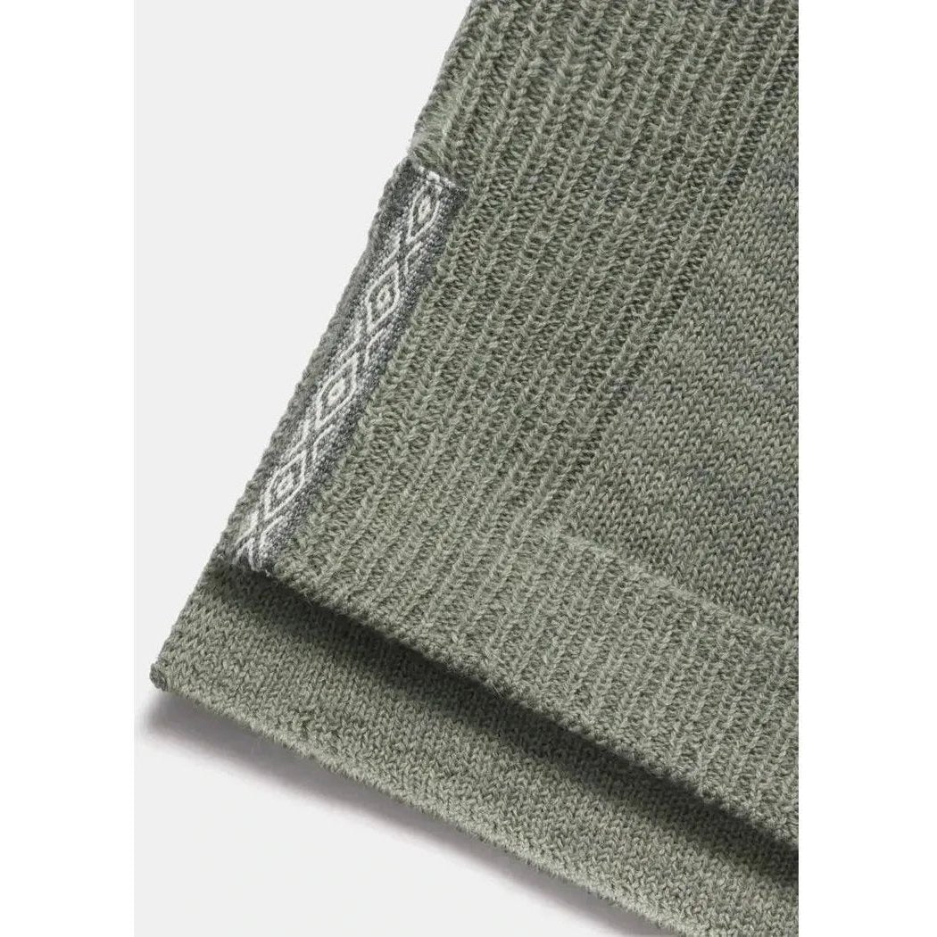 A close-up of the Paka Apparel Women's Hoodie in Willow showing the ribbed cuff and patterned tag against a light background.
