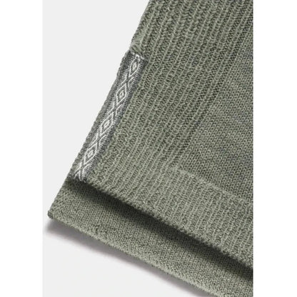 A close-up of the Paka Apparel Women's Hoodie in Willow showing the ribbed cuff and patterned tag against a light background.
