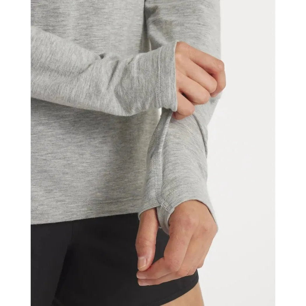 A close-up of the Paka Apparel Women's Sol Hoodie in Heather Grey, showing the long sleeves and a model wearing it against a plain white background.