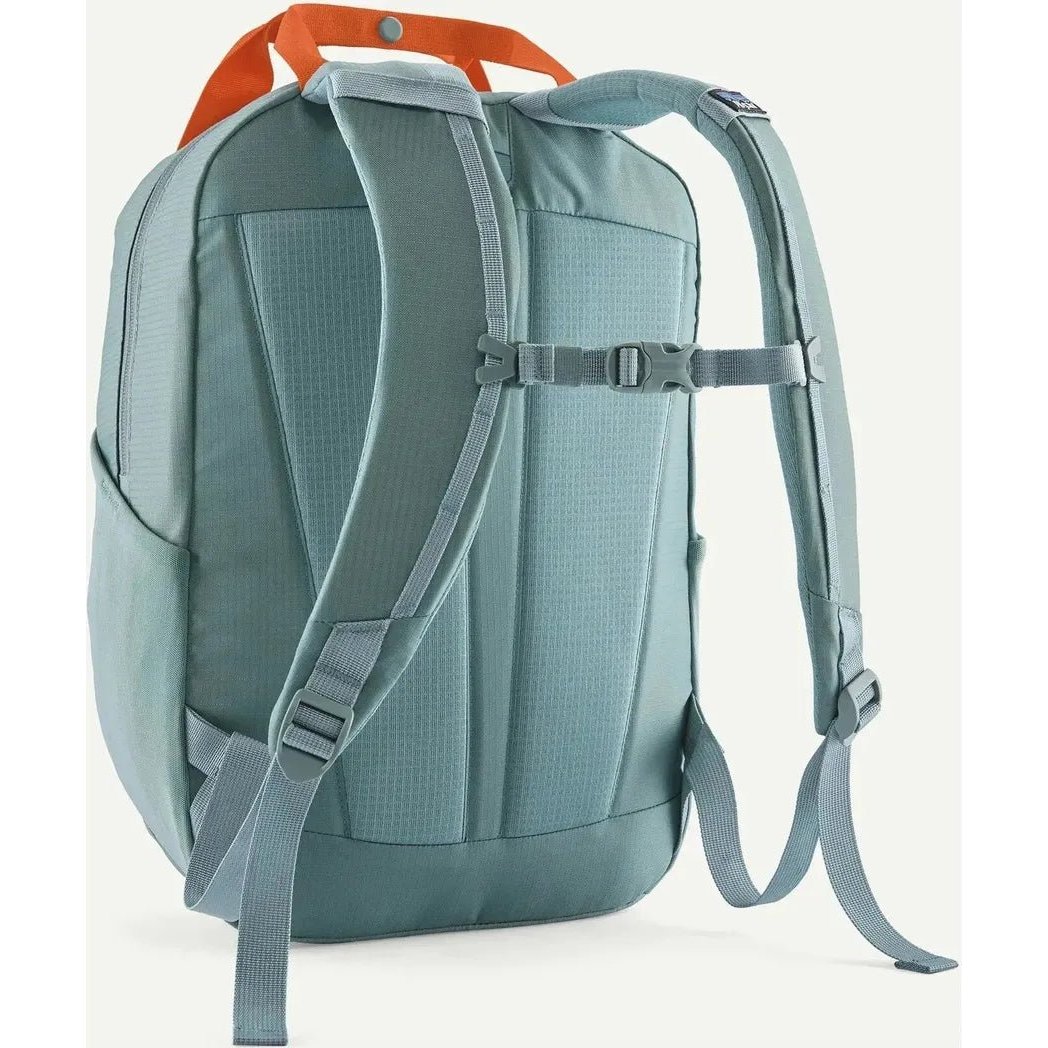 Back view of the Patagonia Atom Tote Pack 20L in Blue Sage showing padded shoulder straps and a white background.