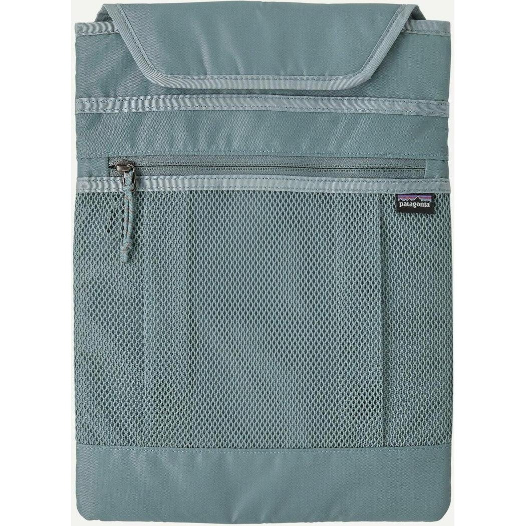 A front view of the Patagonia Atom Tote Pack 20L in Blue Sage showing the mesh pocket and zipper against a white background.