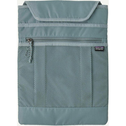 A front view of the Patagonia Atom Tote Pack 20L in Blue Sage showing the mesh pocket and zipper against a white background.