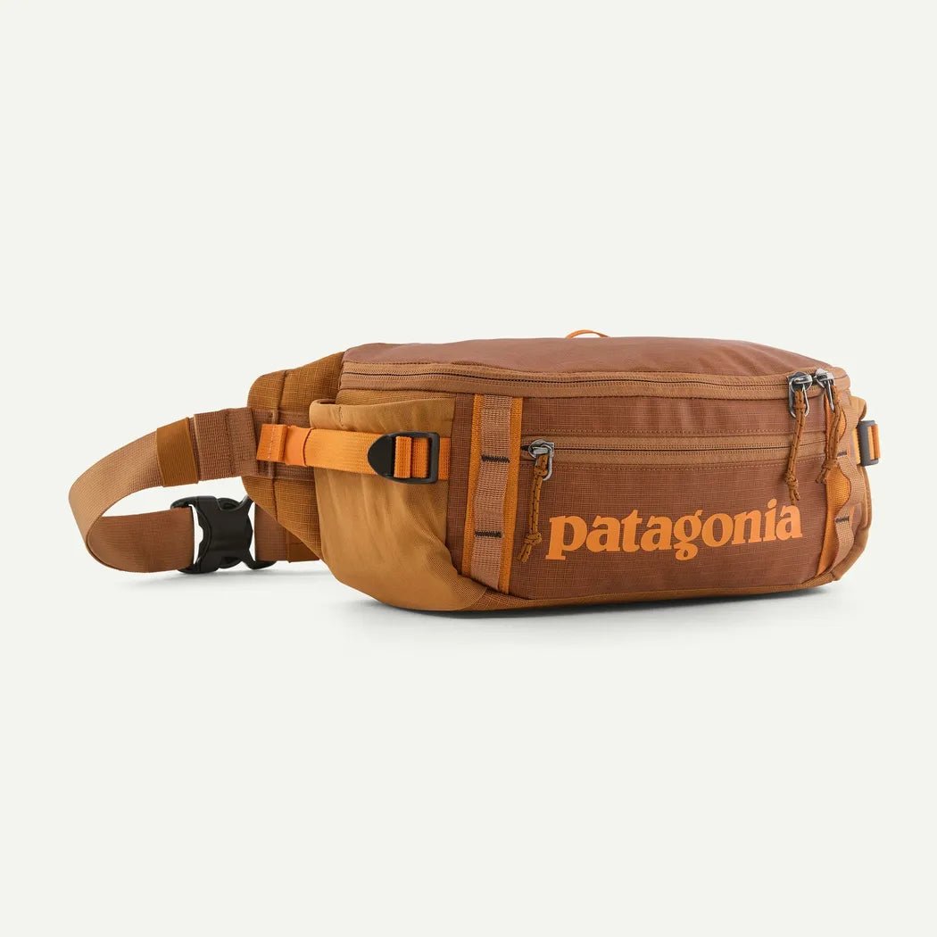 A side view of the Patagonia Black Hole Waist Pack 5L in Black w/Black against a white background.