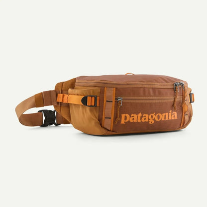 A side view of the Patagonia Black Hole Waist Pack 5L in Black w/Black against a white background.