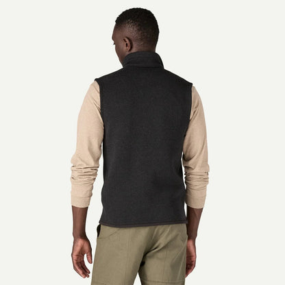 Back view of the Patagonia Men's Better Sweater Vest in Black on a model wearing khaki pants against a white background.