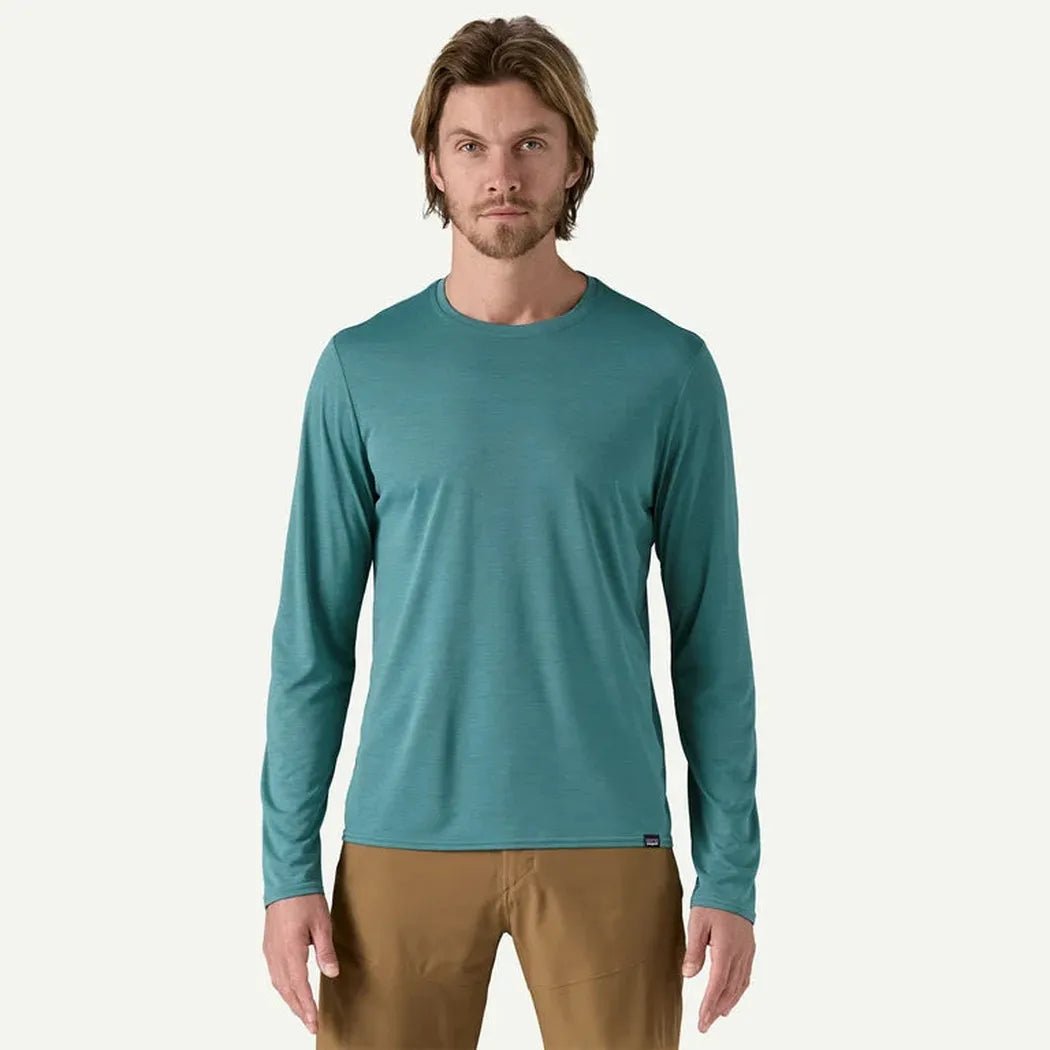 A front view of the Patagonia Men's Long Sleeve Cap Cool Daily Shirt in Wetland Blue, worn by a model against a plain white background.