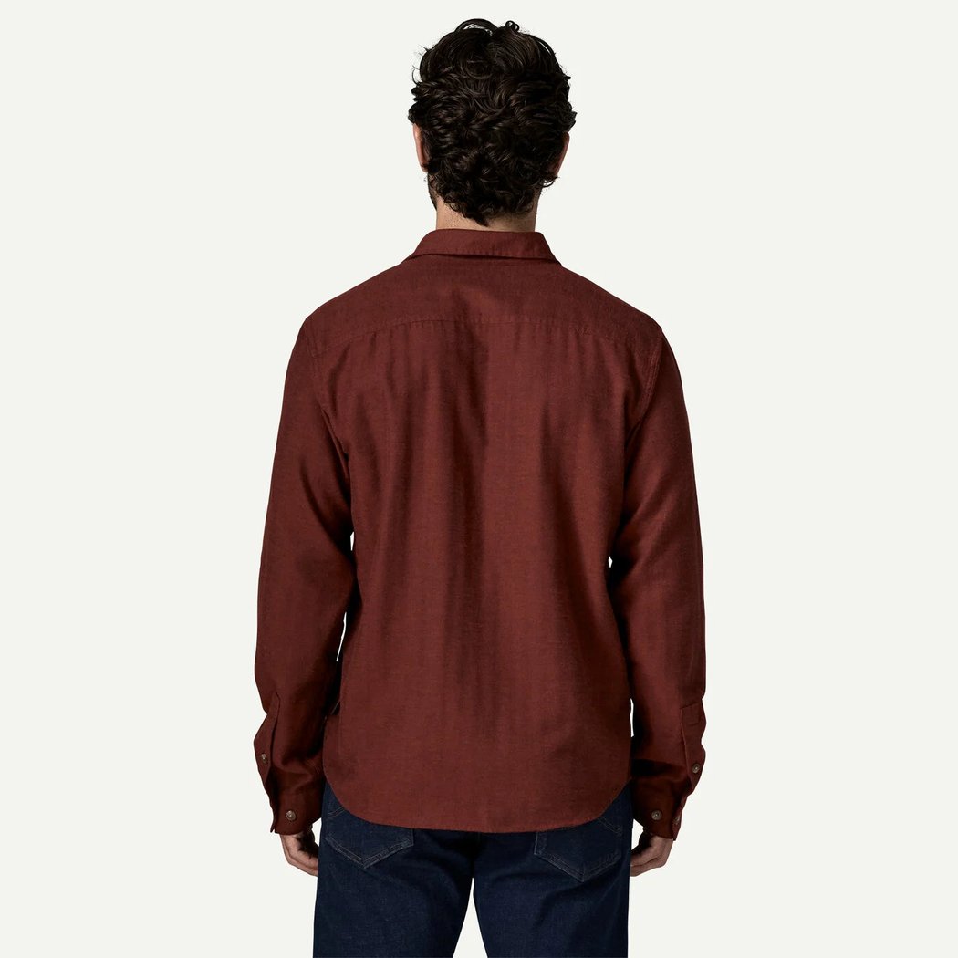 Back view of the Patagonia Men's Long Sleeve Cotton in Conversion LW Fjord Flannel Shirt in Mirror Weave Rusty Red against a white background.