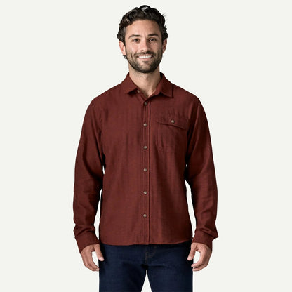 A front view of the Patagonia Men's Long Sleeve Cotton in Conversion LW Fjord Flannel Shirt in Mirror Weave Rusty Red on a model against a white background.