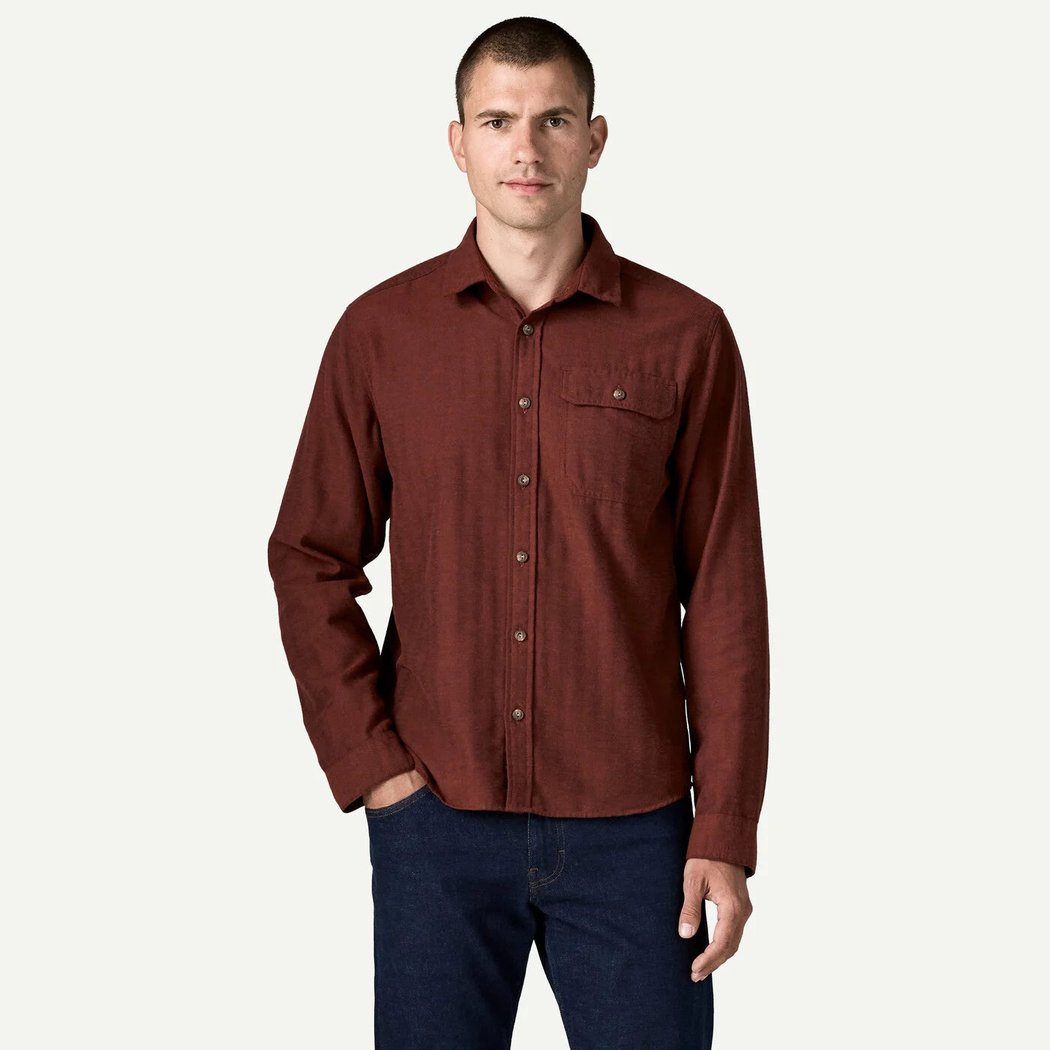 A front view of the Patagonia Men's Long Sleeve Cotton in Conversion LW Fjord Flannel Shirt in Mirror Weave Rusty Red on a model against a white background.