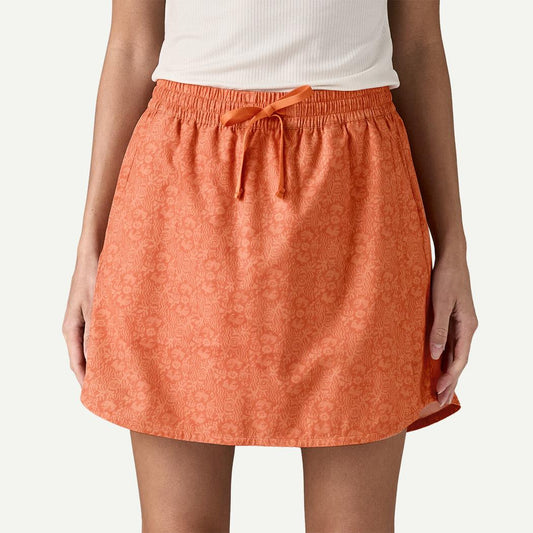 A front view of the Patagonia Women's Fleetwith Skort in Mountain Breeze: Rock Melon, showing the drawstring waist and floral pattern against a white background.