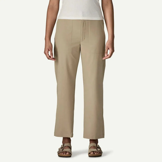 A front view of the Patagonia Women's Roam with Pants in Basin Green on a model wearing sandals against a plain white background.