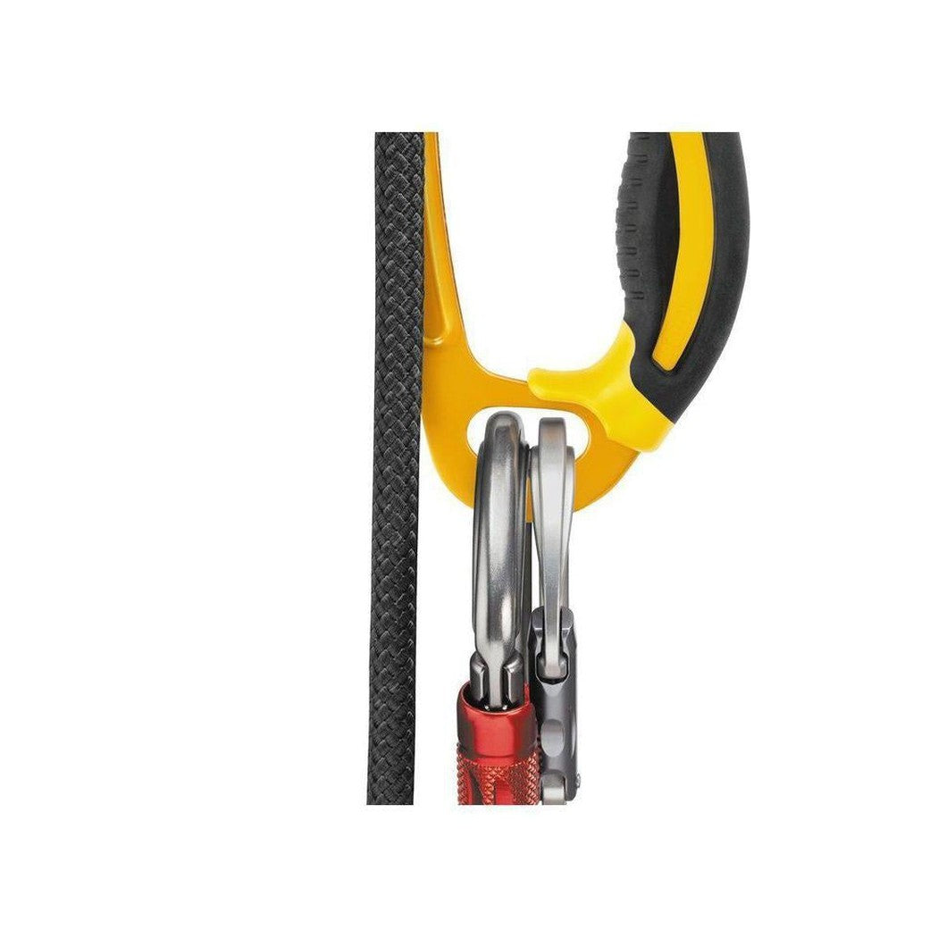 Right side view of the Petzl Ascension Right in Yellow showing the ascender gripping a black climbing rope.
