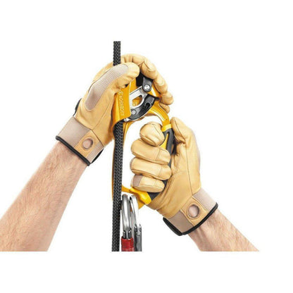 Right hand wearing Petzl Ascension Right yellow climbing ascender gripping a rope with a carabiner below, against a white background.