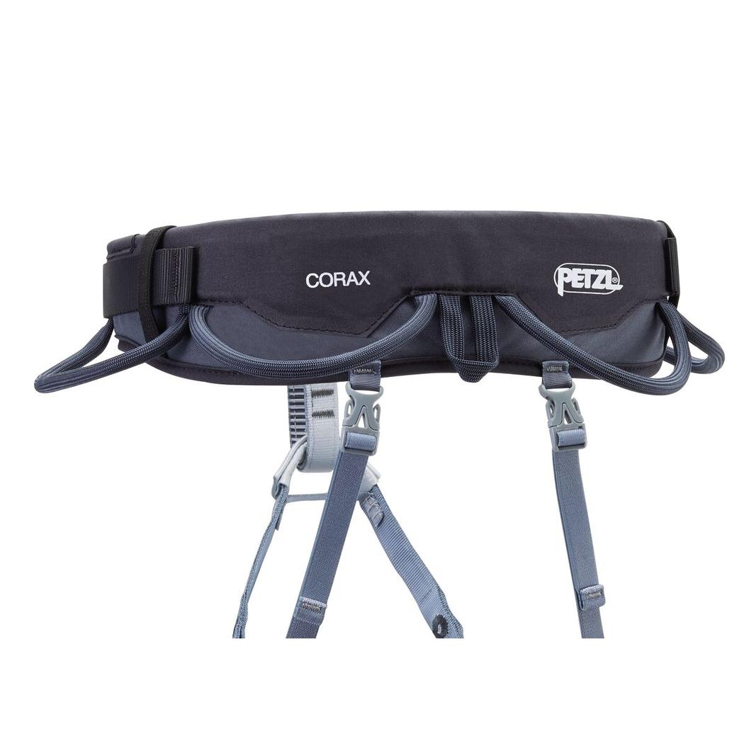 A top-down view of the Petzl Corax dark gray climbing harness with adjustable straps and a white background.