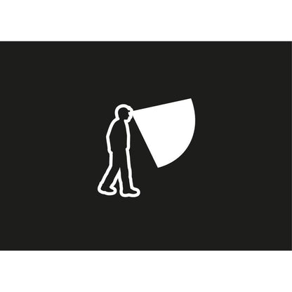 A silhouette of a person wearing the Petzl Tikka Core headlamp with a bright beam against a black background.