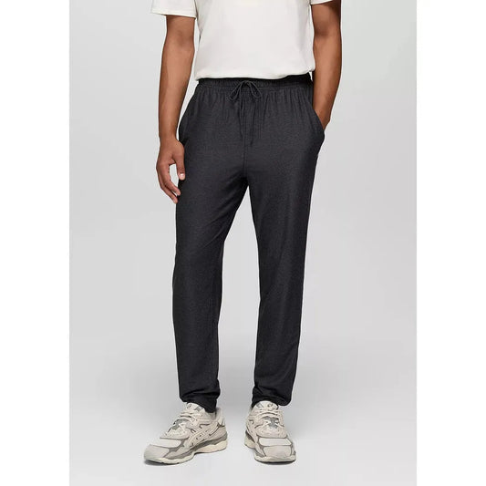 A front view of the Prana Men's Altitude Tracker LT Jogger in Black Heather on a model wearing white sneakers against a plain background.