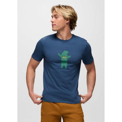 A side view of the Prana Men's Bear Squeeze Journeyman SS Tee in Bluff Blue on a model against a white background.