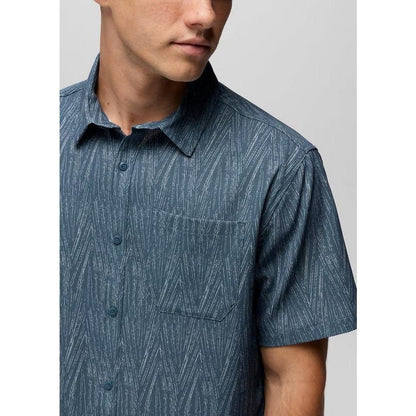 A close-up of the Prana Men's Hybridizer SS Shirt in Bluff Blue Seashell, showing the chest pocket and short sleeves against a plain background.