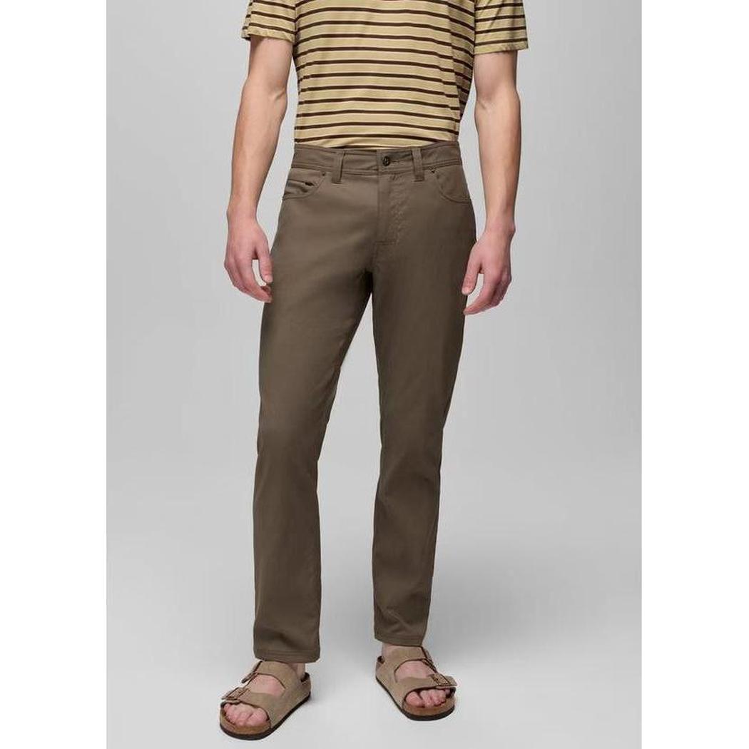 A front view of the Prana Men's Stretch Zion 5 Pocket Standard in Mud showing the model wearing them against a light gray background.
