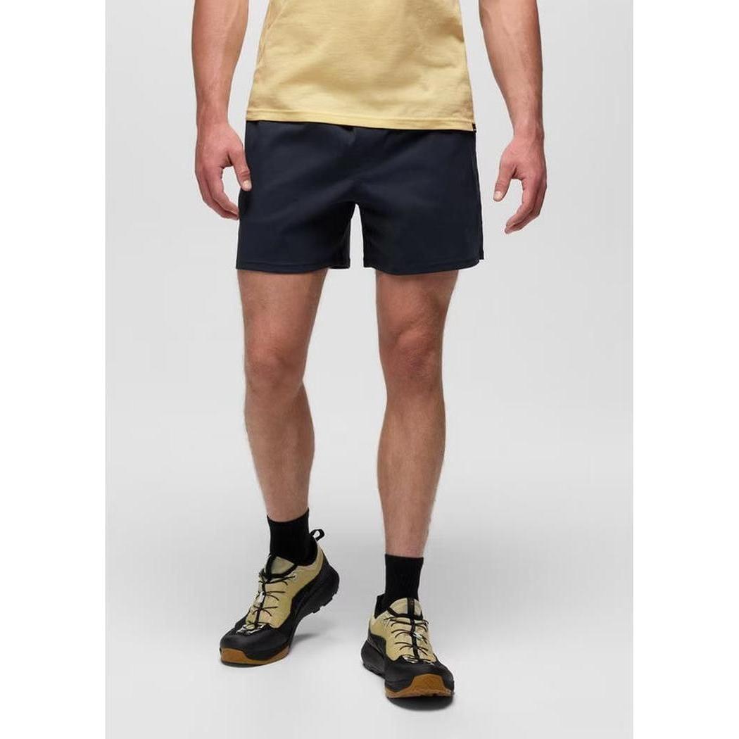 A front view of the Prana Men's Stretch Zion Pull On Short 7" in Nautical, showing the model wearing them with black socks and tan hiking shoes against a plain white background.