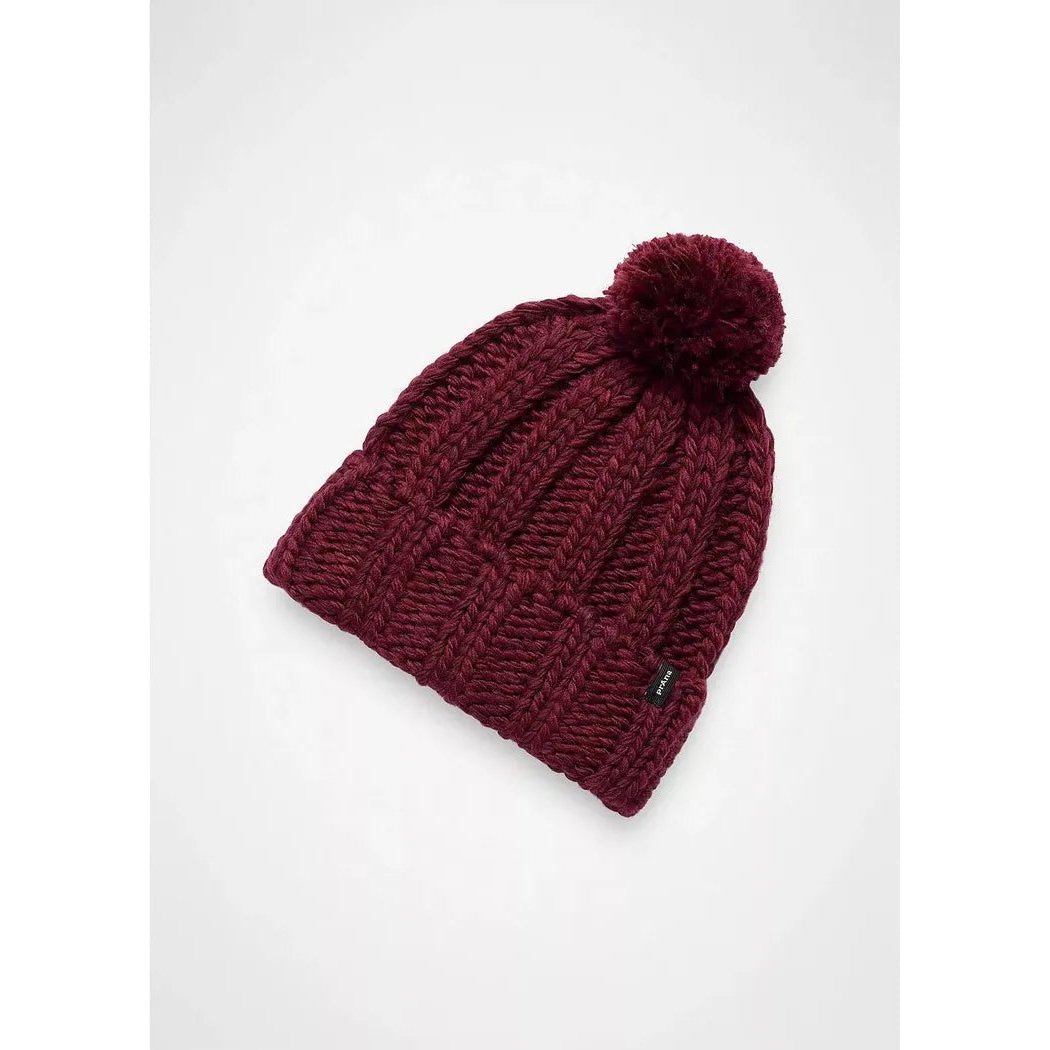 A close-up of the Prana Snow Crystal Beanie in Deep Vino with a pom pom, displayed against a plain white background.