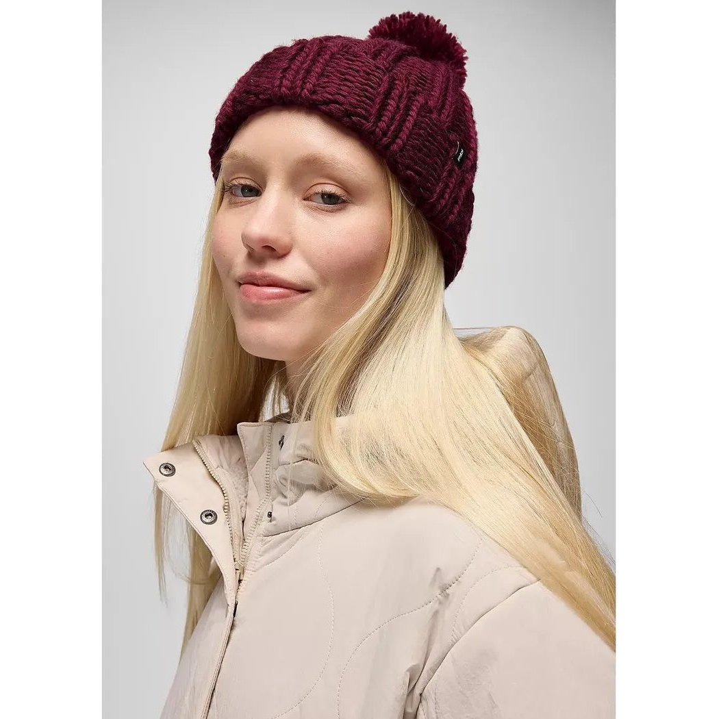 A front view of the Prana Snow Crystal Beanie in Deep Vino on a model wearing a light jacket against a plain background.