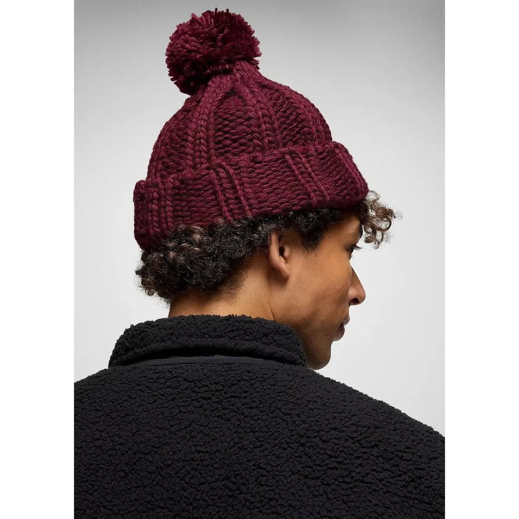 Back view of the Prana Snow Crystal Beanie in Deep Vino on a model wearing a black jacket against a light background.