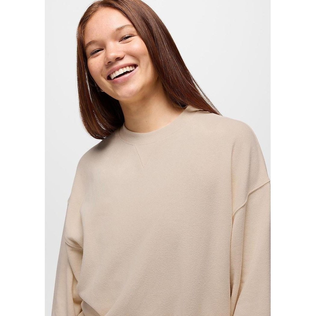 A model wearing the Prana Women's Cozy Up Crew Sweatshirt in Canvas Heather is shown from the front against a plain white background.